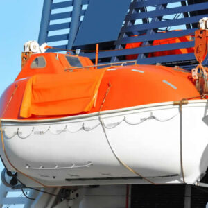 Orange enclosed lifeboat secured on a vessel’s davits