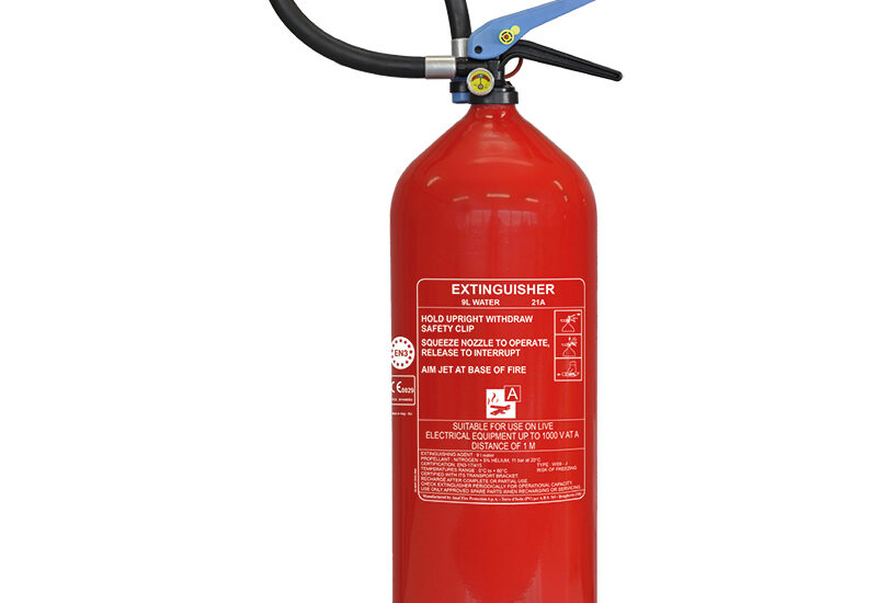 Red portable fire extinguisher with hose, operating handle and identification label
